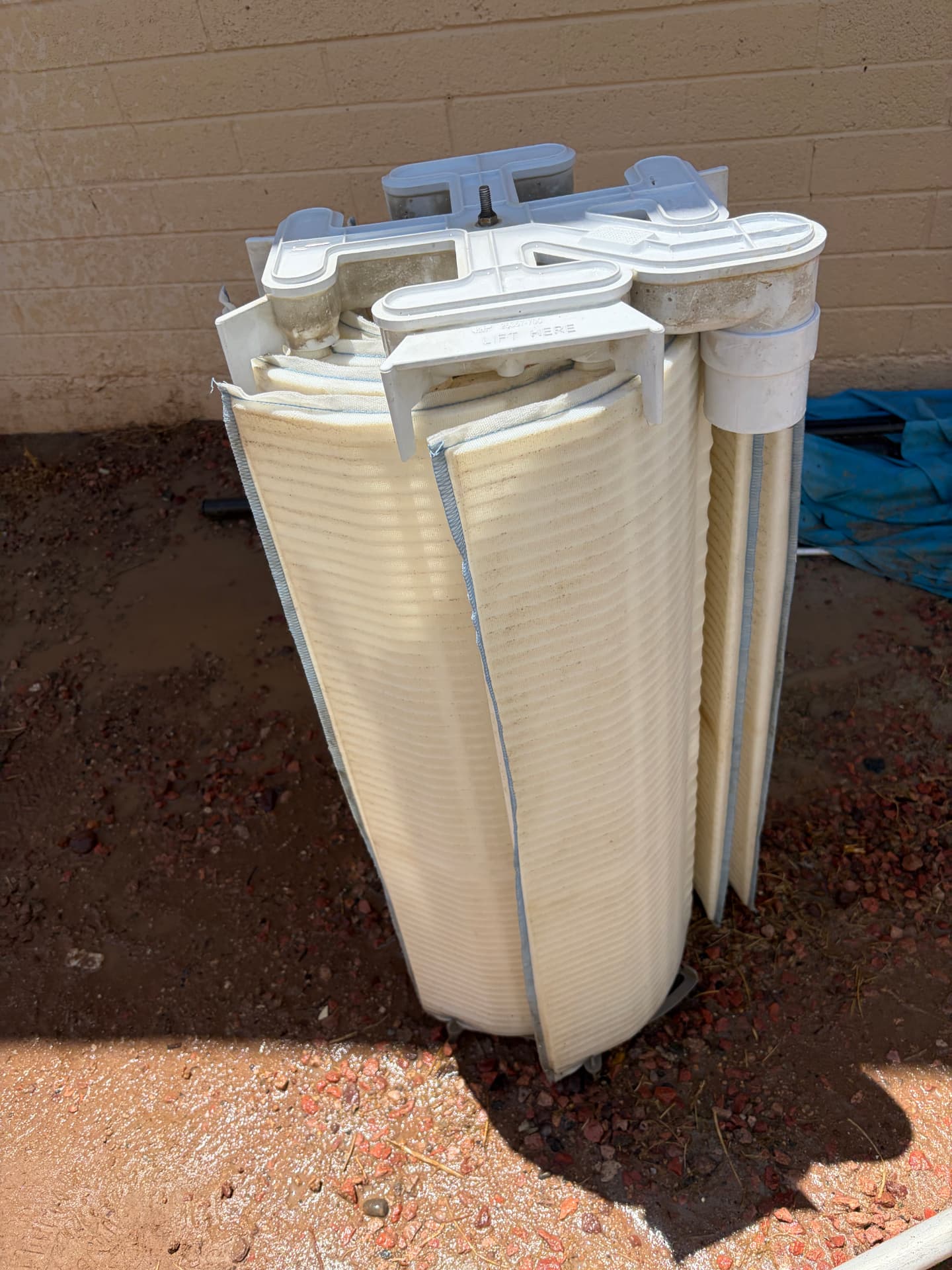 The same diatomaceous earth filter grid assembly standing upright after being rinsed clean